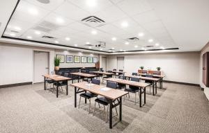 a classroom with tables and chairs in a room at Holiday Inn Express & Suites Baton Rouge East, an IHG Hotel in Baton Rouge