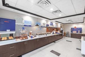 a bakery with a counter with donuts on it at Holiday Inn Express & Suites Baton Rouge East, an IHG Hotel in Baton Rouge