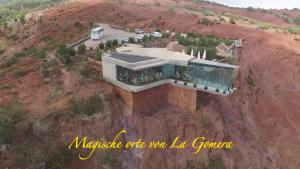 a house on top of a hill with a mountain at Casa Rural Sofia in Hermigua