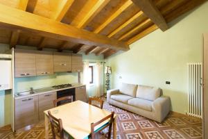 a living room with a table and a couch at Gredo Antica Dimora in Villafranca in Lunigiana