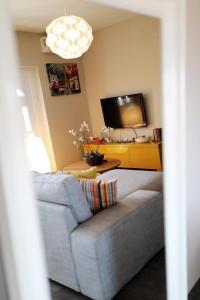 a living room with a couch and a flat screen tv at Luxury Apartment RougeMarin in Pakoštane