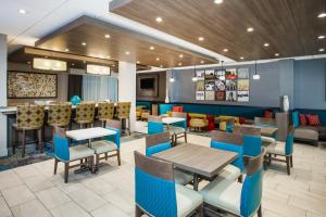 a dining room with tables and chairs in a restaurant at Holiday Inn Express & Suites Litchfield, an IHG Hotel in Litchfield