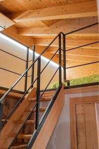 a staircase in a wooden house with wooden ceilings at Pista Stelvio Loft Lumière in Bormio