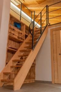 a staircase in a house with wooden walls and ceilings at Pista Stelvio Loft Lumière in Bormio