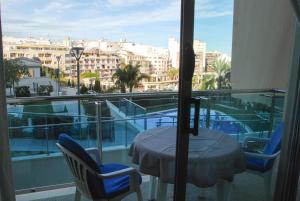 a table and chairs on a balcony with a view of a city at Homeincalpe Borumbot in Calpe