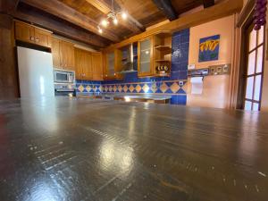 a large kitchen with a concrete floor in a room at CASA LA JUDERÍA in Gea de Albarracín