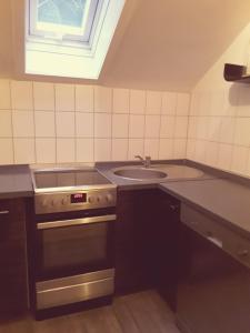 a kitchen with a stove and a sink at Monteurwohnung - Business Apartment in Wertheim