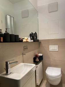 a bathroom with a sink and a toilet at Grace-Design-Apartment - very central in Munich +15 photos