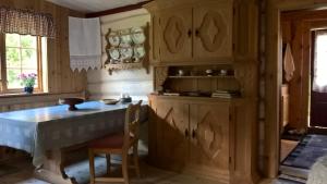 a kitchen with wooden cabinets and a table and chairs at Brekkøye i Lom in Lom +2 photos