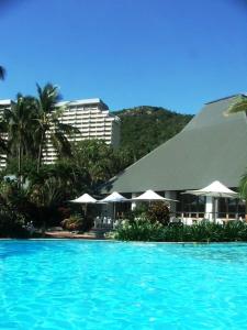 a view of a resort with a large swimming pool at Frangipani Beachfront Lodge F5 on Hamilton Island by HamoRent in Hamilton Island