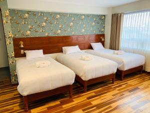 Ένα ή περισσότερα κρεβάτια σε δωμάτιο στο Hotel Daylu
