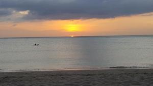 a person in a boat in the ocean at sunset at Home No.9 in Ko Lanta