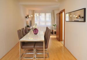 a dining room table and chairs in a room at Selinor Old Town Apartments in Prague