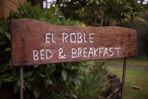 Un cartel que lee "El Rosey Bed and Breakfast" en Hospedaje El Roble, Puerto Varas, en Puerto Varas