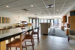 an office lobby with a long counter and chairs at Holiday Inn Express & Suites Aurora - Naperville, an IHG Hotel in Aurora