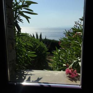 a view of the ocean from a window at Apartment at KiVA-villa, Kampi, KEA, Cyclades, Greece in Ligia