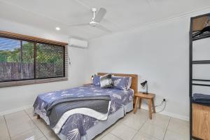 a bedroom with a bed and a window at The Red Sparrow 2 in Cairns