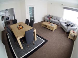 a living room with a table and a couch at The Beardman Armidale in Armidale