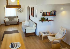 a living room with a couch and chairs and a table at ZOETIC sustainable rooms in Évora