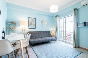 a living room with a couch and a table at Mouzinho Blueapartment in Cabanas de Tavira +12 photos