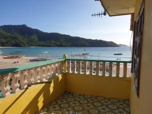 Elle comprend un balcon offrant une vue sur la plage. dans l'établissement Bangkero Cottage, à El Nido