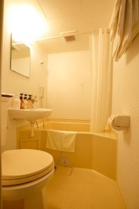 a bathroom with a toilet and a sink at Grampus Inn Osaka in Osaka