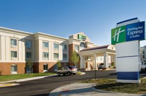 a hotel with a sign in front of a building at Holiday Inn Express & Suites Alexandria - Fort Belvoir, an IHG Hotel in Alexandria