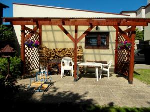 a pavilion with chairs and a table and chairs at Mieszkanie Wakacyjne Adam in Chmielno