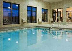 a swimming pool in a hotel with windows and a swimming pool at Holiday Inn Express Hotel and Suites Borger, an IHG Hotel in Borger