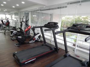 a gym with several tread machines in a room at Apto. Novo e decorado. in Bombinhas