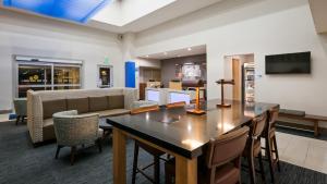 a lobby with a table and chairs and a couch at Holiday Inn Express Hotel & Suites Everett, an IHG Hotel in Everett