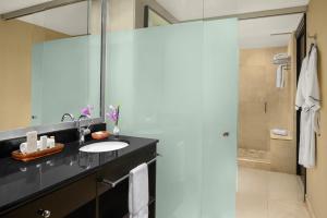 a bathroom with a sink, mirror, and shower at Z Ocean Hotel South Beach in Miami Beach