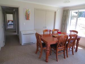 a dining room with a wooden table and chairs at waikawa house in Niagara