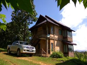 a car parked in front of a house at Khunyuam Resort in Ban Khun Yuam