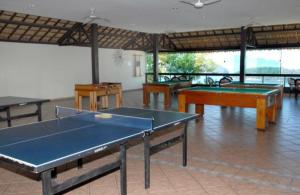 a room with several ping pong tables in it at Porto Real Suites Resort in Mangaratiba