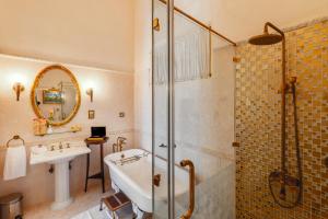 a bathroom with a sink and a shower at Dalat Palace Heritage Hotel in Da Lat