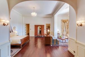 a bedroom with a bed and a living room at Dalat Palace Heritage Hotel in Da Lat