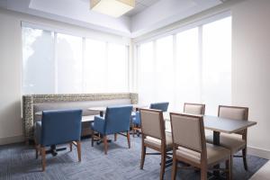 a conference room with tables and chairs and large windows at Holiday Inn Express Hotel & Suites Chattanooga Downtown, an IHG Hotel in Chattanooga