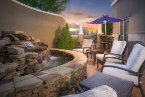 a patio with a pond and chairs and an umbrella at Holiday Inn Express Hotel & Suites Chattanooga Downtown by IHG in Chattanooga +25 photos