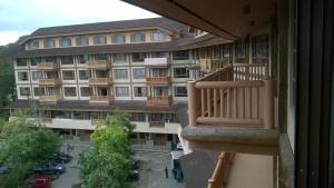 a view of a building from a balcony at Private Unit Forest Lodge Lodge Camp John Hay in Baguio