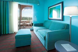 a living room with a blue couch and a table at Holiday Inn Hotel & Suites Ocala Conference Center by IHG in Ocala