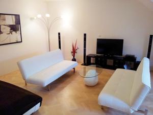 a living room filled with furniture and a tv at Selinor Old Town Apartments in Prague