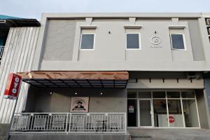 a white building with a sign on the front of it at Super OYO 2756 Anata in Makassar