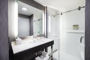 a bathroom with two sinks and a mirror at Staybridge Suites - Quincy, an IHG Hotel in Quincy