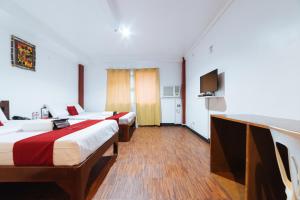 Postel nebo postele na pokoji v ubytování RedDoorz at Nirvana Pension House