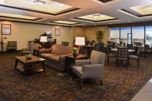 a hotel lobby with couches and tables and chairs at Holiday Inn Express & Suites Fairmont, an IHG Hotel in Fairmont