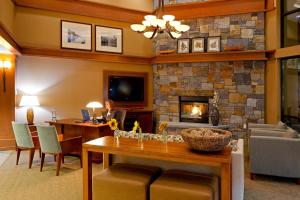 a man sitting at a desk in a living room with a fireplace at Holiday Inn Resort Lake George, an IHG Hotel in Lake George