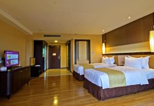 Een bed of bedden in een kamer bij Grand Lagoi Hotel by Willson