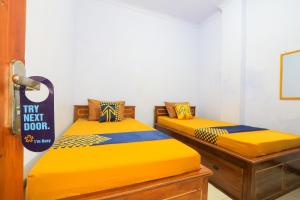 Postel nebo postele na pokoji v ubytování OYO 2497 Pesona Guest House
