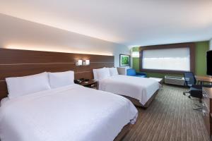 a hotel room with two beds and a desk at Holiday Inn Express & Suites - Brenham South, an IHG Hotel in Brenham